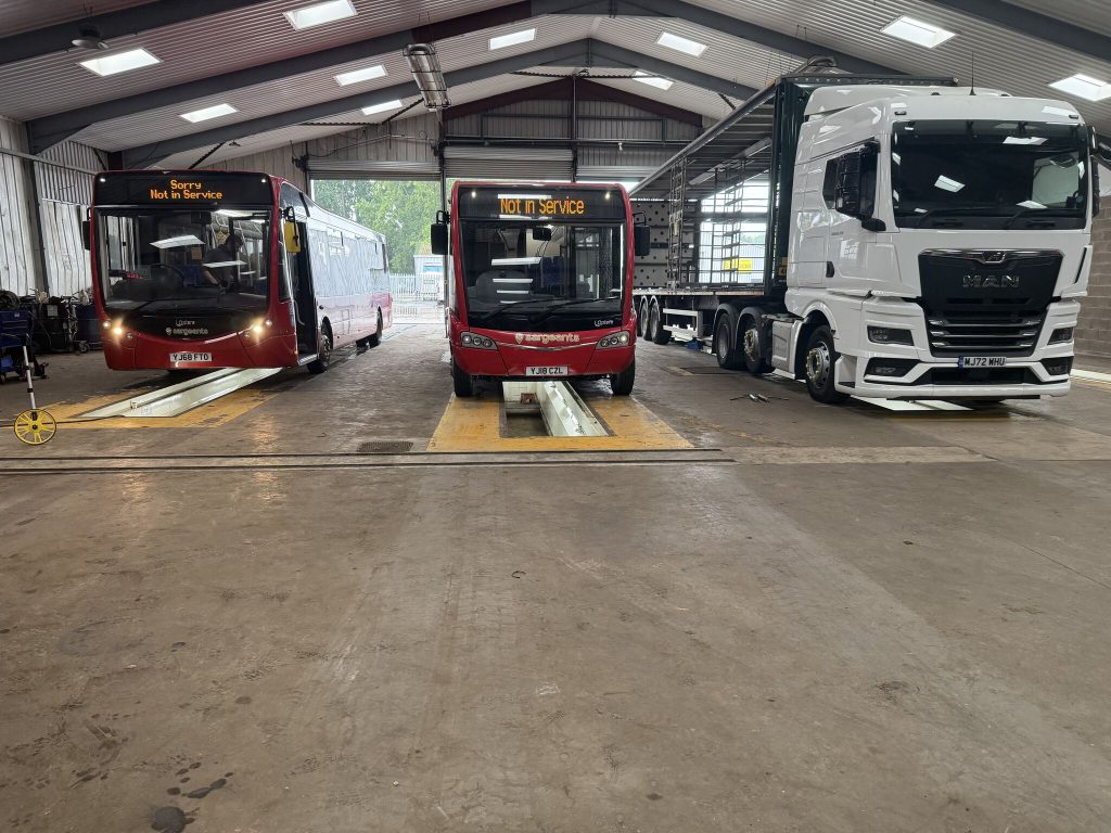 Worn workshop floor and vehicle bays before the new resin floor
