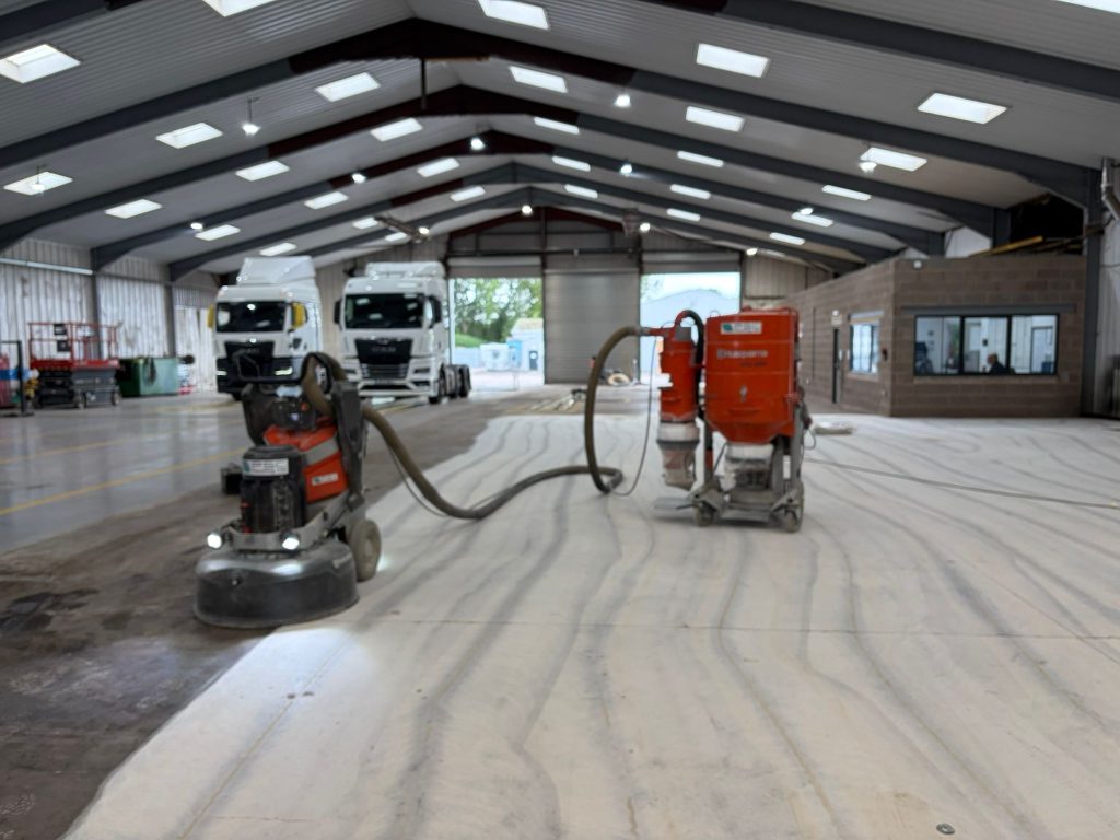 Triple-headed diamond grinder preparing the workshop floor
