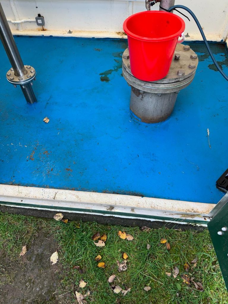 Original blue coating around the wellhead before refurbishment