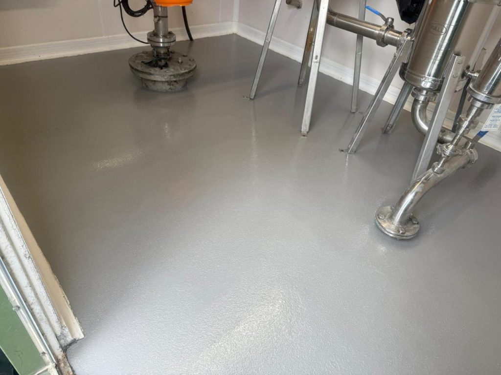 Finished grey Pumadur RT floor inside a borehole pump house