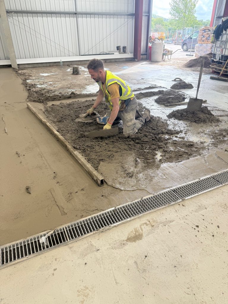 Polymer screed laid to falls beside a drainage channel