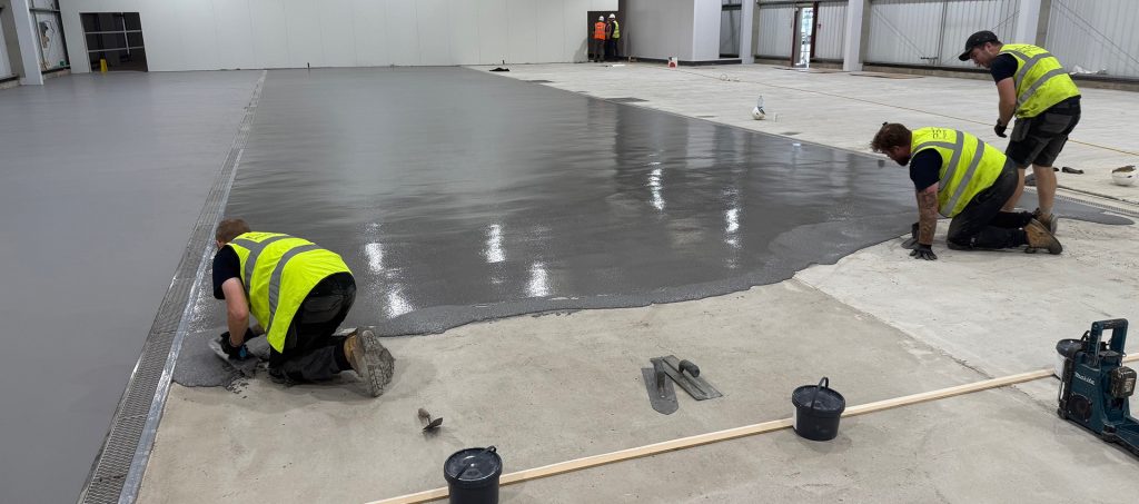 PSC Flooring team applying Pumadur HF polyurethane screed