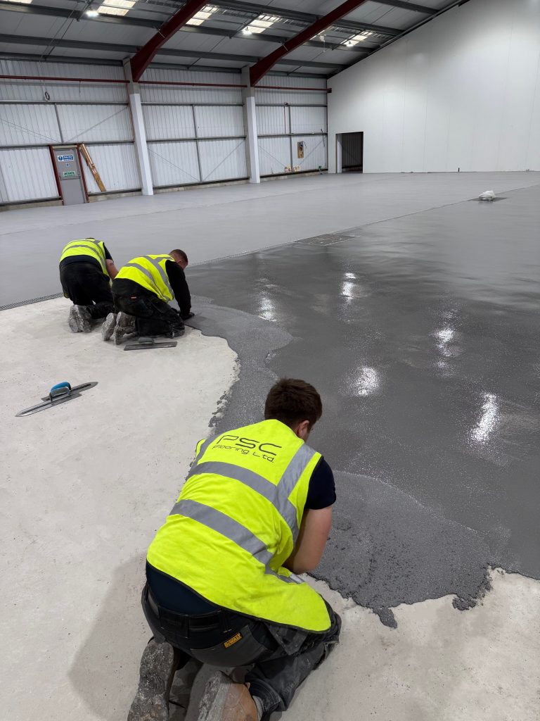 Installation team laying Pumadur HF resin screed
