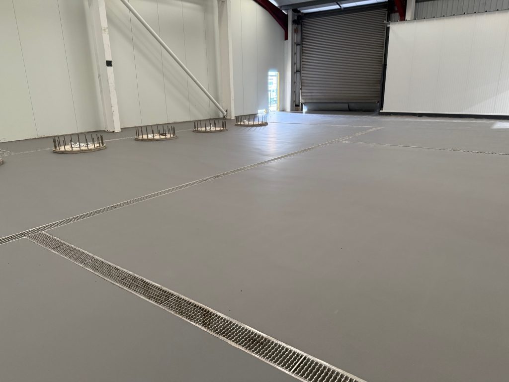 Finished floor with drainage channels and falls