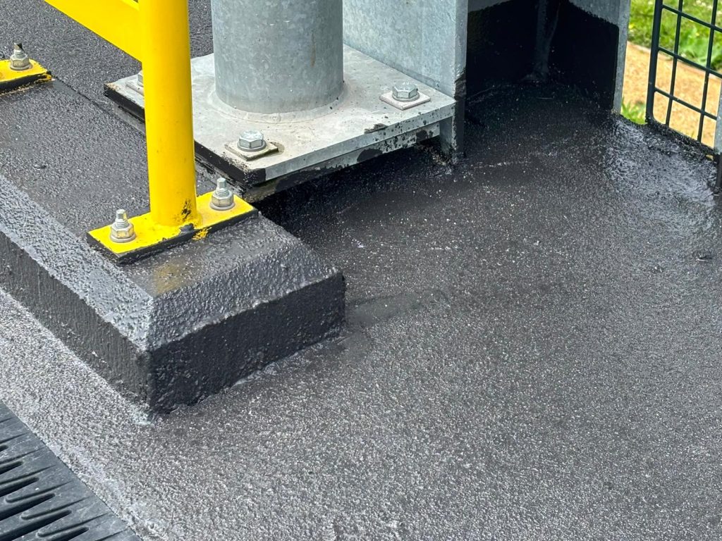 Waterproofing detail around a bollard base